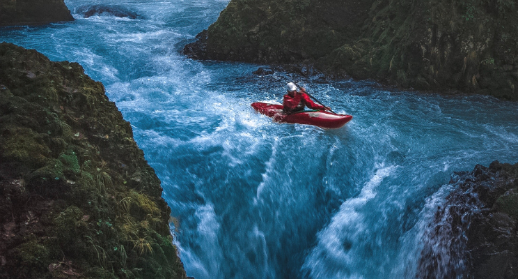 person kayaking in river