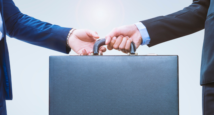 handing over brief case