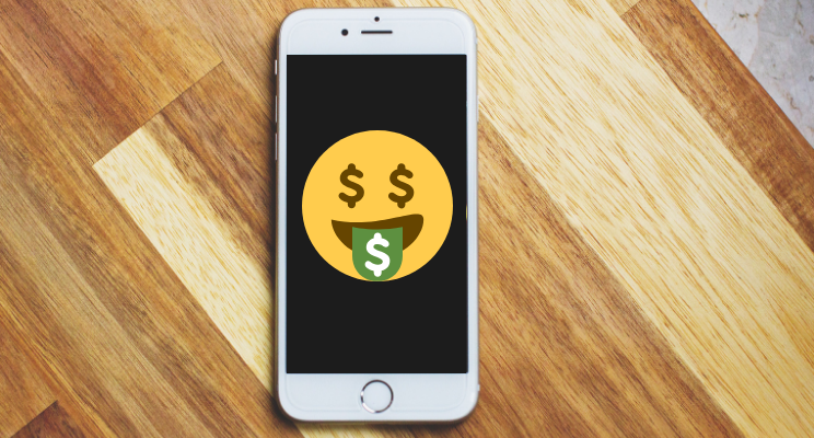 emoji on cellphone sticking out tongue with dollar sign on tongue and eyes