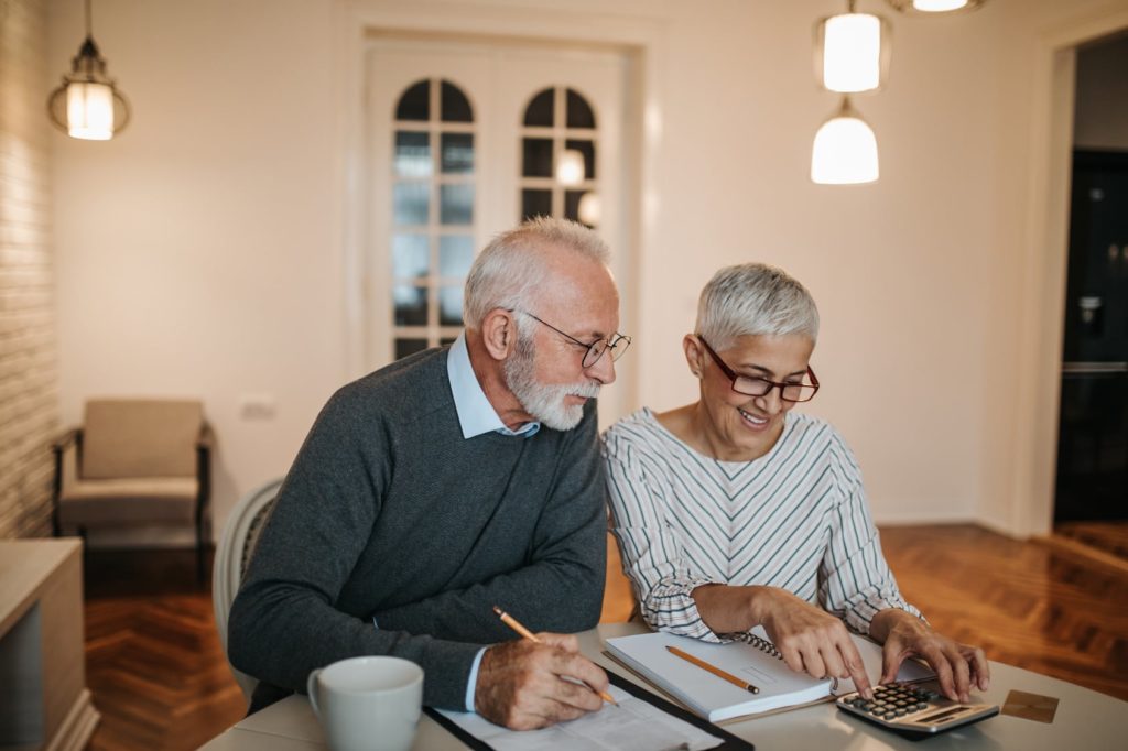 elderly couple looking over finances