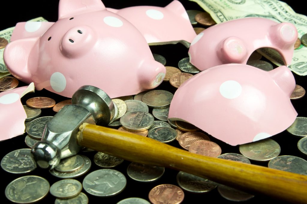 broken piggy bank with hammer