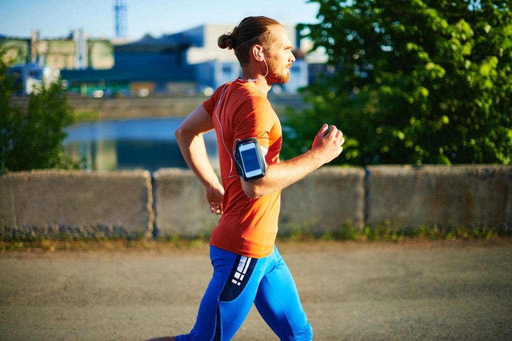 man jogging while listening to music