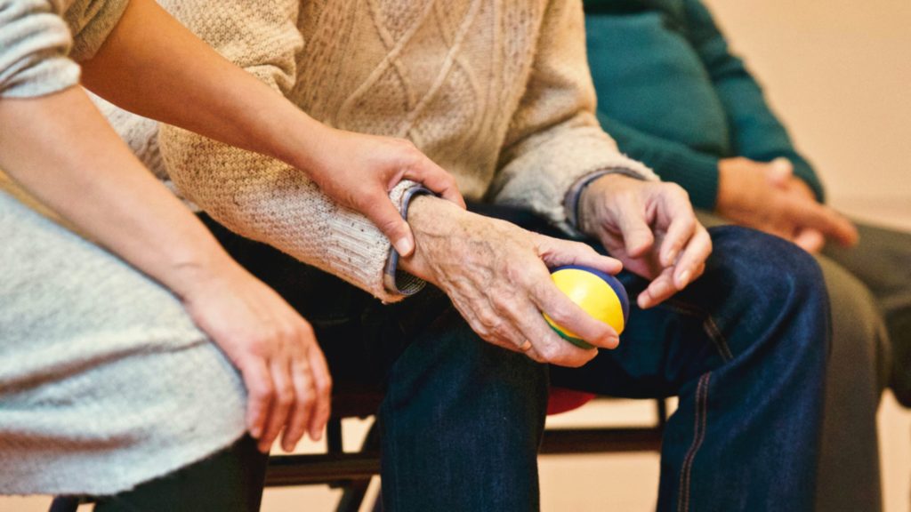 holding elderly mans arm