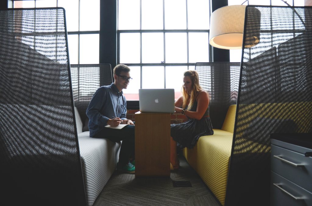 man and woman looking at laptop