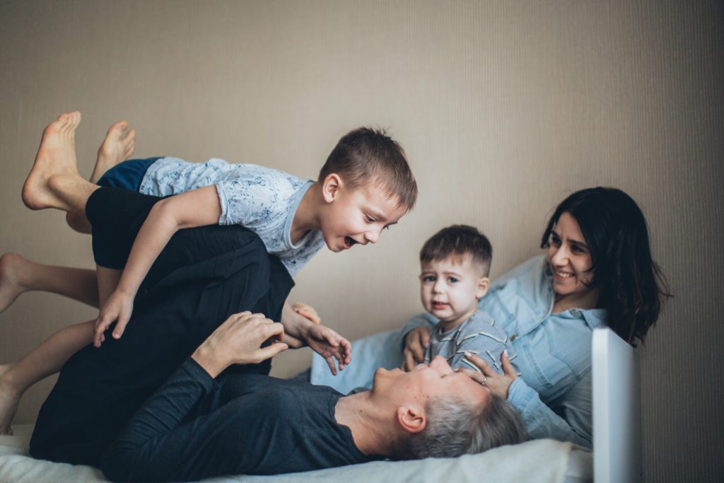 family playing on bed