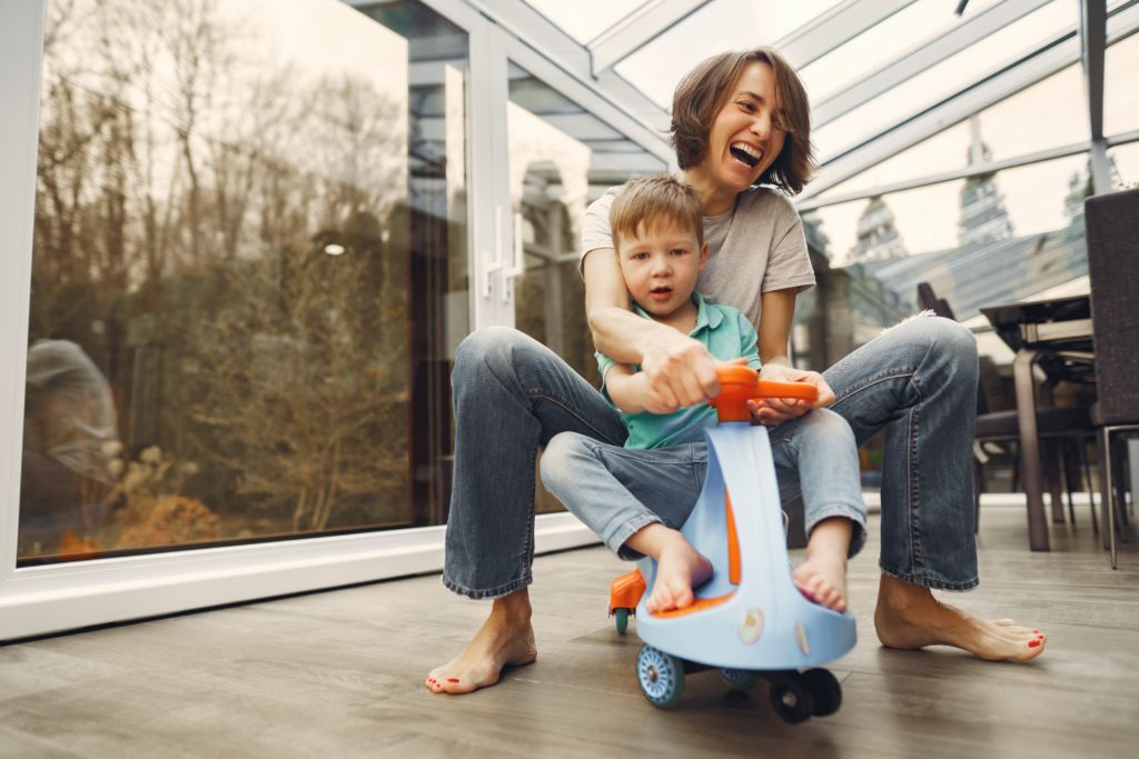 mom and son riding childs scooter